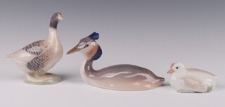 A Royal Copenhagen figure of a standing duck 1088 13cm, ditto seated bird 3263 15cm and a chick 266 9cm 