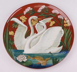 A Mintons faience aesthetic art pottery charger decorated with swans and a goldfish amongst flowers, impressed marks, and numbered 15, 39cm 