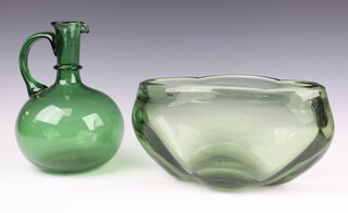 A green studio glass baluster ewer of simple form 22cm and a Whitefriars style bottle green freeform bowl 26cm 
