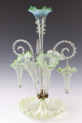 A Victorian vaseline glass epergne with a large centre stem vase 3 medium vases and three suspended baskets 18cm and 19cm with a ditto dish base 56cm h 