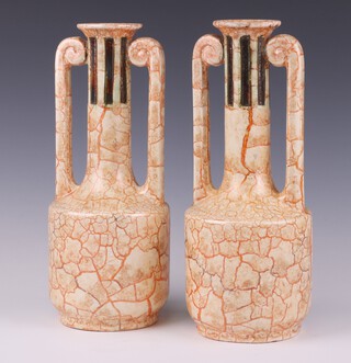 A pair of Art Deco moulded twin handled vases with extended necks 31cm 
