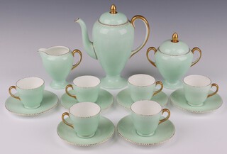 An Art Deco Wedgwood coffee set with pale green and gilt decoration comprising coffee pot, sugar bowl, cream jug, 6 cups and 6 saucers