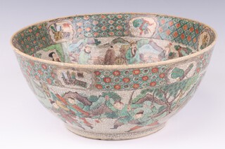 An early 20th Century famille verte punch bowl decorated with a band of figures and figures on horse back, 27cm 