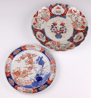 An Imari scallop plate decorated with panels of flowers 31cm, ditto of a garden landscape enclosed by panels of landscapes 26cm 
