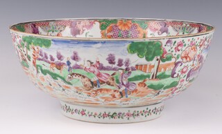 An 18th Century Chinese famille rose bowl decorated with European figures on horseback with a pack of hounds and alternate panels of figures in landscapes, the interior with a huntsman and pack of hounds, 28cm 