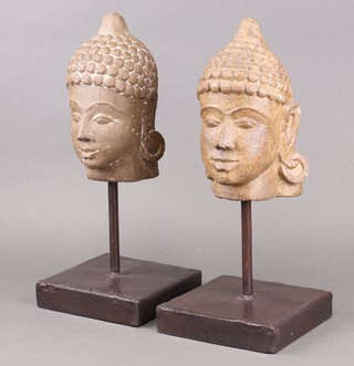 A near pair of carved hardstone Buddhistic busts, raised on a metal stand 45cm 