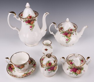 A Royal Albert Old Country Roses tea and coffee set comprising 9 tea cups (1 a second), 9 saucers (1 a second), coffee pot (a/f) and lid (chipped), teapot and lid, sugar bowl and lid, preserve pot and lid, bowl and lid, vase, leaf shaped dish and spoon, milk jug, salt and pepper, 8 small plates, 2 tier cake stand, sandwich plate, teapot stand, cake stand, 2 knives and a vase 