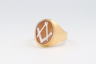 A gentleman's 18ct yellow gold carved cameo Masonic ring with square and compass, size W, 6.8 grams