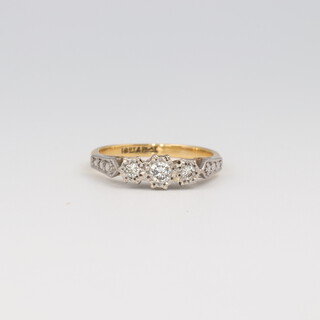 An 18ct yellow gold 3 stone diamond ring, the illusion set diamonds approx. 0.14ct, size K, 2.8 grams