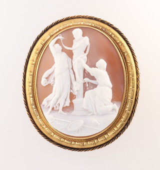 A good Victorian carved cameo brooch in a yellow gold, testing as 18ct Greek key pattern mount, depicting attendants dressing Pan, indistinctly signed on verso Schmidt? 65mm, x 60mm, 26.4 grams gross, in original fitted box 
