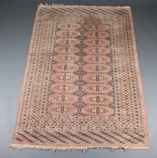 A pink, black and white ground Bokhara rug with 9 stylised diamond medallions to the centre, flanked by 20 stylised diamond medallions within a multi row border 188cm x 128cm 