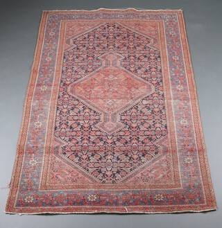 A red, blue and green ground North Persian rug with central medallion within a multi row border 209cm x 131cm 