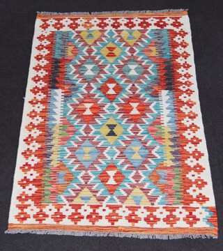 A white, turquoise and green ground Chobi Kilim with all over diamond design 122cm x 80cm