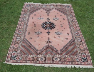 A pink and blue ground Moroccan carpet with central medallion within a multi row border 303cm x 213cm 