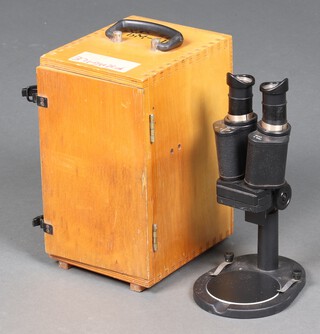 A Russian binocular microscope contained in a carrying case 