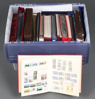 A collection of GB first day covers in a plastic box 