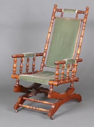 An American turned beech rocking chair upholstered in green material