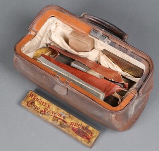 A leather Gladstone bag containing a collection of sign writers paint brushes 
