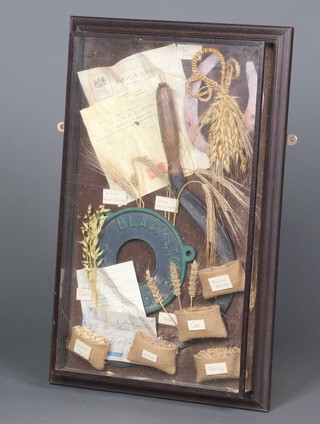 A rural diorama with scythe, horseshoe, oats, etc 71cm x 45cm, framed