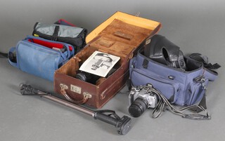Two Canon SLR E0S600 and EOS650 cameras, 2 Canon digital EOS300V and a Bolex 250 together with camera bags and spare lenses 