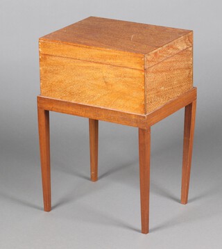 A mahogany sewing box with hinged lid and fitted interior, raised on square tapered supports 61cm x 41cm x 32cm 