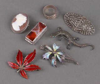 A silver and enamel brooch in the form of a leaf, a similar brooch, a silver buckle ring, a white metal and hard stone pill box and other items