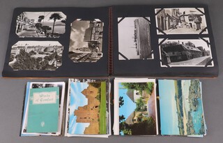 An album of black and white and coloured postcard and various loose postcards