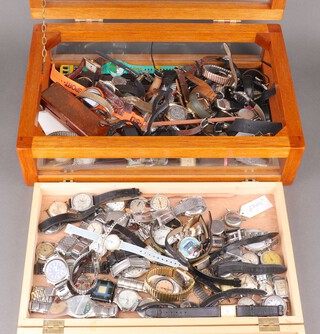 A large quantity of vintage wristwatches and a wooden display case