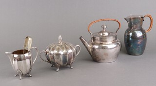 A silver plated tea kettle, hot water jug, sugar bowl, cream jug and sugar nips