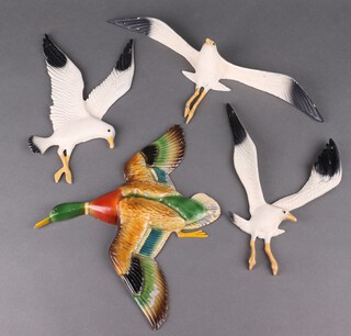 3 painted metal wall plaques in the form of seagulls and one other in the form of a mallard duck