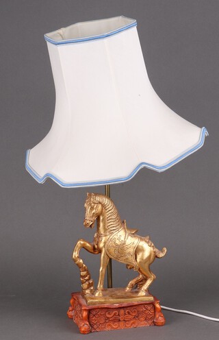 A composition table lamp in the form of a gilt Tang horse raised on a plinth  