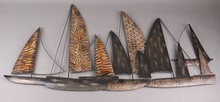 A pressed metal wall hanging sculpture of boats 