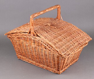 A twin compartment wicker picnic basket 