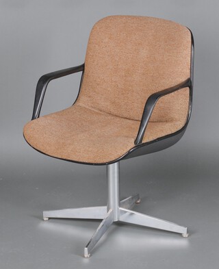 A 1980s revolving office chair raised on chrome supports