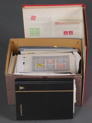 A red stock stamp album of mint and used GB stamps, a black Centurion stamp album, a collection of first day covers and stamped postcards 