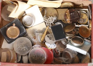 A small leather case containing a quantity of watch movements, parts, watch cases etc 