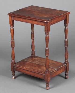 A 1930's oak 2 tier occasional table on turned supports 70cm x 51cm x 40cm 