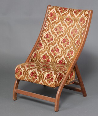 An Edwardian beech framed tub back chair in floral patterned material