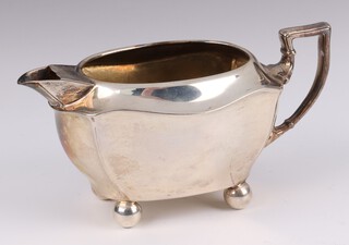 A silver boat shaped cream jug on bun feet, maker John Rogers and Co., Sheffield 1899, 126 grams  