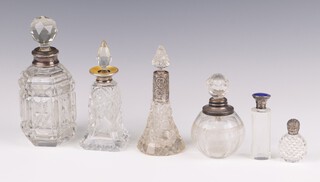 A hexagonal cut glass dressing table jar with silver mounts and cut glass stopper (stopper chipped), a cut glass perfume bottle with silver and yellow enamelled collar 9cm (the top off centred) and 4 other glass scent bottles with silver collars 