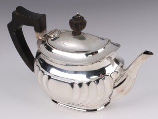 A Victorian silver bachelor's teapot with demi-reeded decoration and ebonised handle, Sheffield 1889, maker Atkin Brothers, gross weight 438 grams 