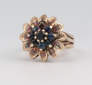 A yellow gold, testing as 9ct, mid-century sapphire set cluster ring, set with 8 (ex 9) sapphires each approx. 0.01ct, size K 1/2, 5.3 grams 