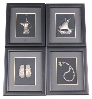 Four Saudi Arabia 925 standard silver models of coffee pot, pair of slippers, necklace and dowel, all contained in ebonised frames 14cm x 12cm 