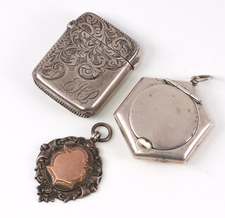 An engraved silver vesta case Birmingham 1901, a hexagonal silver compact and a silver sports fob, 38 grams 