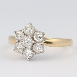 An 18ct yellow gold 7 stone diamond cluster ring, the diamonds each approx. 0.15ct, size O, 4.7 grams 
