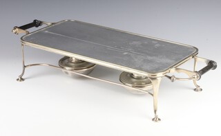An Edwardian silver plated plate warmer with glass top and 3 burners on scroll feet 66cm