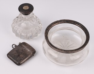 A silver vesta case with engined turned decoration Birmingham 1919, a circular cut glass bowl with silver rim 9cm and a cut glass dressing table jar with silver collar 7cm (stopper missing) 