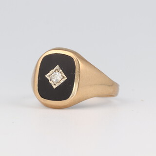 A gentleman's 9ct yellow gold onyx and diamond signet ring, the diamond approx. 0.03ct, size U 1/2, 3.3 grams 