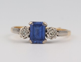 An 18ct yellow gold sapphire and diamond ring, the emerald cut sapphire approx. 0.75ct, the 2 brilliant cut diamonds each approx. 0.3ct, size P 1/2, 3.1 grams 