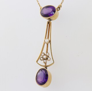 An Edwardian yellow gold testing as 9ct amethyst and seed pearl pendant, the 2 oval amethysts approx. 1ct each, the pendant 4cm, the necklace 40cm 